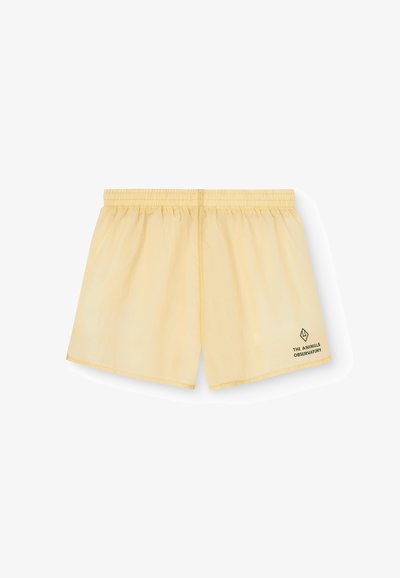 Gula badbyxor i lättviktsmaterial, med resårmidja och en liten svart logotyp längst ner till höger.