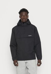Black windbreaker jacket with a front pocket, adjustable hood, and elastic cuffs. Made from a lightweight, water-resistant fabric.