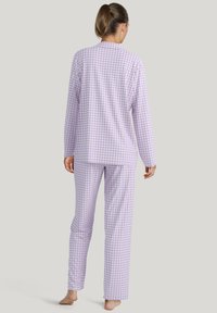 Light purple gingham pajama set with long sleeves and pants. Soft fabric, relaxed fit, and a collar detail on the top.