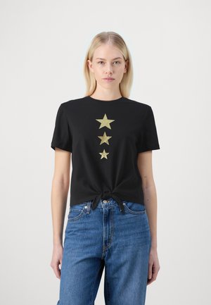 Black cotton t-shirt with a knotted design at the waist and three gold glitter stars printed vertically on the front.