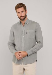 Camicia button-up grigio chiaro in un mix di lino, con taschino sul petto e maniche lunghe. Tessuto morbido con un design sottile e casual.