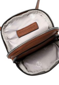 Small zippered bag made of brown leather with a silver zipper, featuring a grey lined interior and a branded leather label inside.