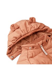 Peach-colored padded jacket with a hood featuring bear ears, smooth texture, ribbed collar, and a zipper with a branded pull tab.
