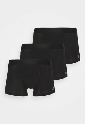 Bóxer negro fabricado con tela suave, con una cintura lisa y un discreto detalle de logo. Tres pares se muestran apilados.