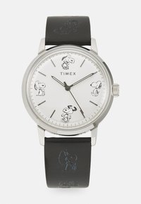 Timex watch with a silver case, white dial featuring Snoopy illustrations, black leather strap with embossed Snoopy design.