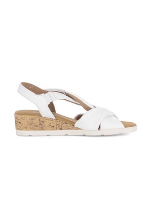 White leather wedge sandal with crisscross straps and cork-textured sole, featuring a back strap with adjustable closure.
