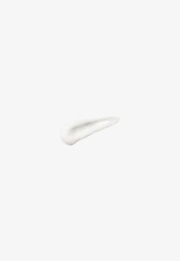 Small amount of white cream or lotion spread on a plain white background, shaped like a teardrop or paint smear.