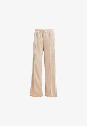 Beżowe dresy wykonane z gładkiego materiału, o luźnym kroju, z elastycznym pasem na sznurek i subtelnymi bocznymi paskami.