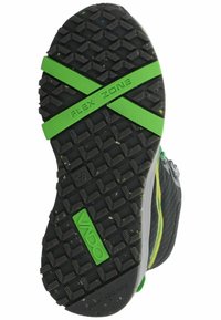 Suela de zapato de goma negra con un dibujo en relieve. Presenta acentos en verde "FLEX ZONE" y un logotipo texturizado en verde, con motas de colores en toda su superficie.