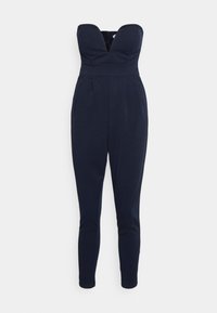 Macacão sem alças azul-marinho com decote profundo, pernas ajustadas e bolsos laterais, feito de um tecido suave e texturizado.