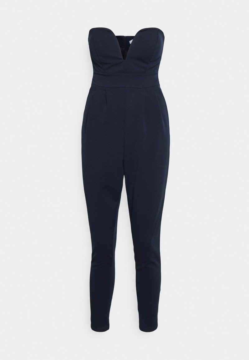 Macacão sem alças azul-marinho com decote profundo, pernas ajustadas e bolsos laterais, feito de um tecido suave e texturizado.