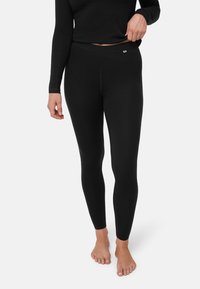 Sorte leggings lavet af glat stof med høj talje og et lille logomærke foran. Tætsiddende design ned til anklerne.