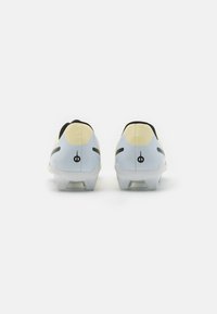 Football boots featuring a sleek design with a light blue upper, yellow accents, and black detailing. The sole has molded studs for grip.