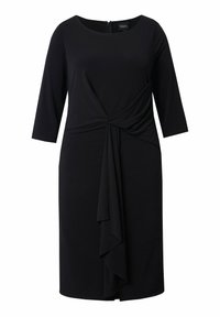 Vestido negro con mangas tres cuartos, diseño retorcido en la cintura y detalle de volante en la parte delantera en capas. Tela suave y elástica. Cremallera en la parte posterior.