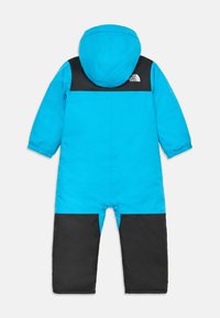 Mėlynas ir juodas vaikiškas snowsuit'as su kepure. Ypatybės: vientisas mėlynas torso ir juodi akcentai ant pečių ir kojų. Pagamintas iš minkštos, patvarios medžiagos.