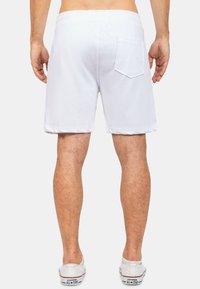 Witte katoenen shorts met een elastische tailleband en een achterzak. Glad textuur, boven de knie ontwerp, geschikt voor casual draag.