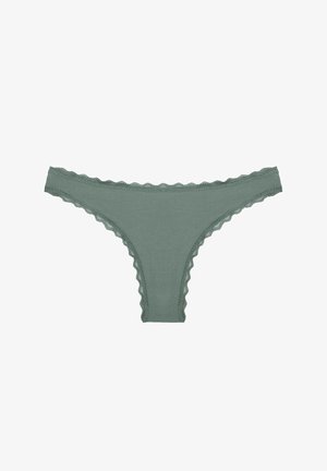 Green lace-trimmed thong made of soft material. Features scalloped edges along the waistband and leg openings.