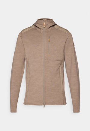 Light brown zip-up jacket with a hood, featuring textured fabric, shoulder accents, and a chest pocket with a zipper.