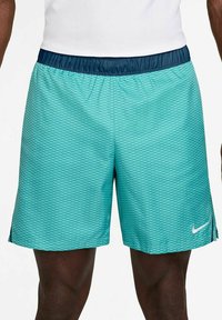 Turquoise athletic shorts with a diamond pattern, elastic navy waistband, and a white Nike logo on the lower front right side.