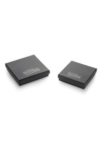 Two square, black, matte boxes with a sleek design, featuring a printed "TRUE REBELS!" logo in a contrasting color on the top surface.