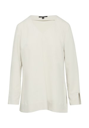 Jasnobeżowa bluzka z długim rękawem i dekoltem w serek. Gładka tkanina, boki z rozcięciami, luźny krój. Brak widocznych wzorów lub dodatków. Minimalistyczny design.