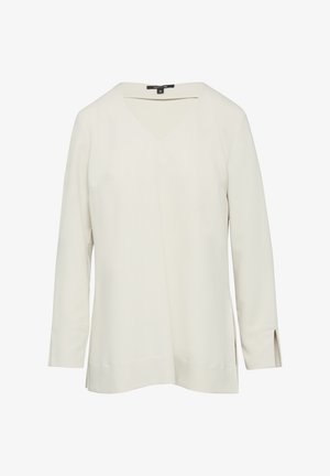 Jasnobeżowa bluzka z długim rękawem i dekoltem w serek. Gładka tkanina, boki z rozcięciami, luźny krój. Brak widocznych wzorów lub dodatków. Minimalistyczny design.