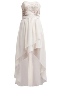 Ilta-asu ilman olkaimia, vaalean kermanvärinen, jossa on kirjailtuja kukkakuviota, virtaava kerroksellinen hame ja epäsymmetrinen helman muoto. Kevyt kangas.