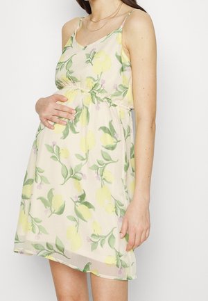 Florales Kleid mit Zitronen- und grünen Blättermotiv, blassgelber Hintergrund, Spaghettiträger, elastischer Bund, leichter Stoff.