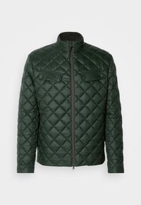 Veste verte matelassée avec un col haut, fermeture éclair à l'avant et deux poches poitrine. Présente un motif diagonal et une texture lisse et soyeuse.