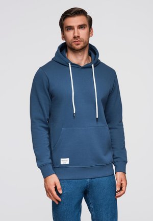 Felpa blu con tasca a marsupio, coulisse bianche e polsini a costine. Realizzata in tessuto morbido con una finitura liscia. Etichetta visibile sull'orlo.