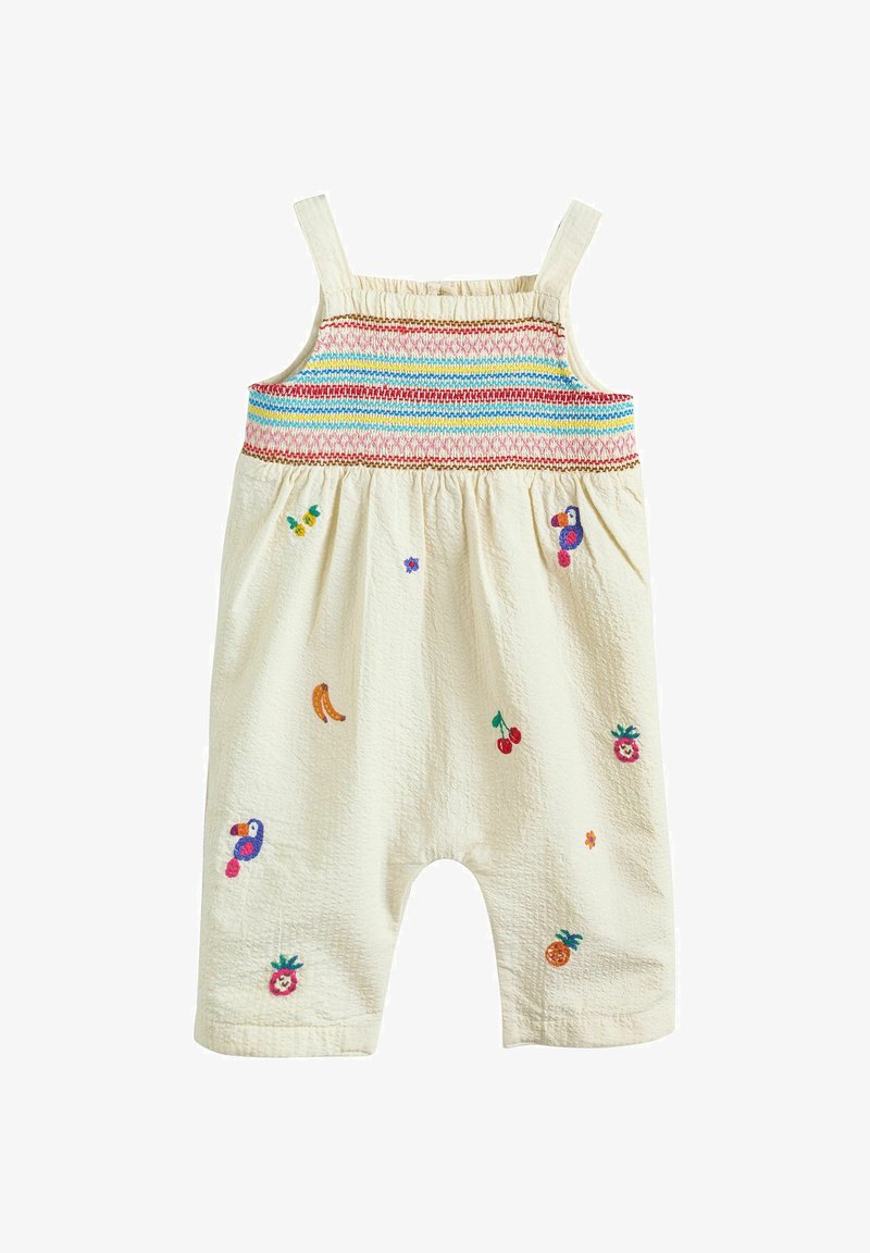 Combinaison crème pour tout-petit avec un haut smocké multicolore et des fruits et oiseaux brodés dispersés sur les jambes et le torse.