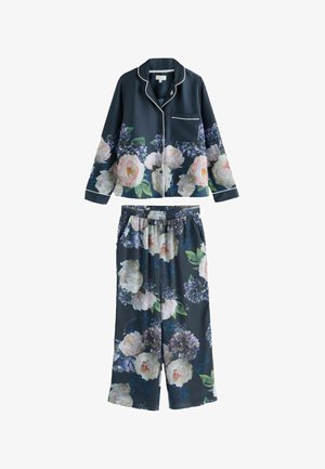 Tamsiai mėlynas pižamos rinkinys su gėlių raštu. Įeina ilgomis rankovėmis palaidinė su baltais kraštais ir kelnės su elastine juosmens dalimi. Minkšta, lengva medžiaga.