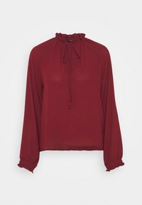 Blusa bordeaux a maniche lunghe con colletto alto arricciato e dettaglio con fiocco, caratterizzata da polsini elasticizzati e una vestibilità rilassata. Materiale morbido e leggero.