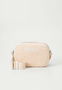 Woven pink bag with a rectangular shape, featuring the word "HUGO" in white, detachable strap, and a zippered closure.