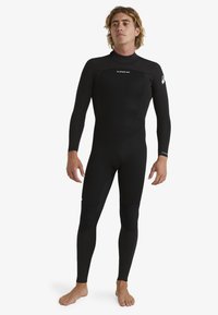 Black wetsuit made from stretch neoprene. Features long sleeves, fitted design, reinforced knee panels, and logo accents on chest and sleeve.
