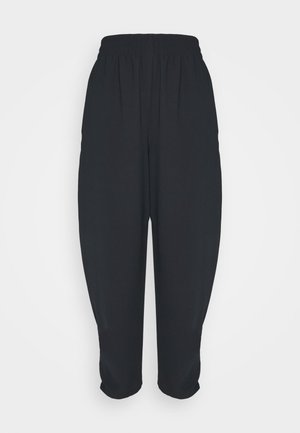 Black loose-fit cropped pants with elastic waistband, tapered legs, and a slightly wrinkled texture, displayed on a white background.