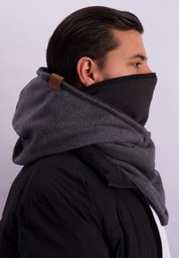 Gray and black fleece neck gaiter with a hood, featuring a leather logo tag. The material appears soft and thick for warmth.