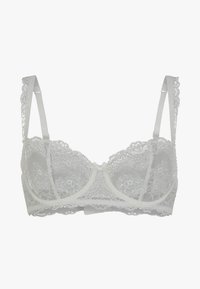 Soutien-gorge en dentelle blanche avec de délicats motifs floraux, des bretelles réglables, un nœud au centre et un design de coque structuré.