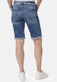 Denimshorts mit umgeschlagenen Säumen, mittlerer Waschung und Gesäßtaschen. Verfügt über eine weiche Textur und ein klassisches Fünf-Taschen-Design.