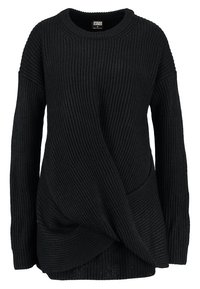 Pull en maille noire avec une texture côtelée, coupe oversize et design asymétrique avec un détail de devant torsadé.