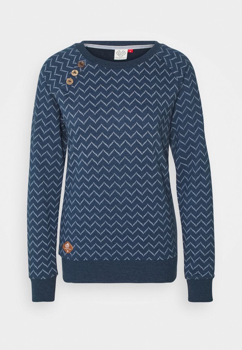 Pull bleu marine présentant un motif en zigzag, des poignets et un ourlet côtelés, trois boutons décoratifs sur l'épaule, et une étiquette de marque sur le côté.