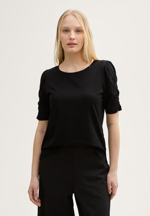 Black short-sleeve top featuring a round neckline and gathered puff sleeves. Made from smooth fabric with a relaxed fit.