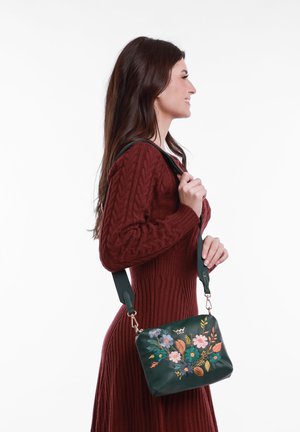 Green leather handbag with floral embroidery, rectangular shape, detachable strap, and gold hardware accents.