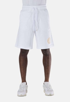 Pantaloni corti bianchi di lunghezza media con vita regolabile tramite cordoncino e dettaglio del logo ricamato in oro sulla gamba sinistra. Tessuto in misto cotone con una consistenza liscia.