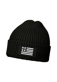 Black knitted beanie with a ribbed texture and a folded cuff, featuring a rectangular patch with a stylized white flag design.