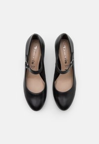 Chaussures Mary Jane en cuir noir avec bouts arrondis, sangles à boucle, semelles intérieures beiges et marquages taille 37, vues de dessus sur fond blanc.