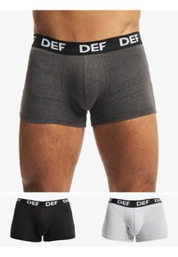Gray boxer shorts with a contrasting black waistband labeled "DEF." Displayed with black and gray variants below. Soft, elastic fabric.