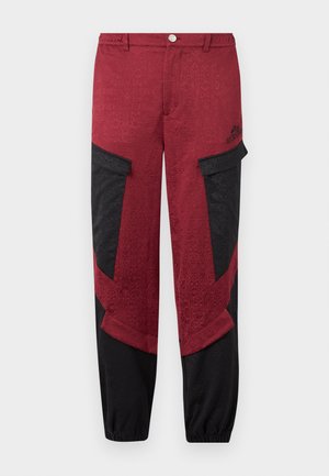 Rode en zwarte cargo broek met een textuurpatroon, voorzien van zijzakken en een elastische manchet bij de enkels voor een verstelbare pasvorm.