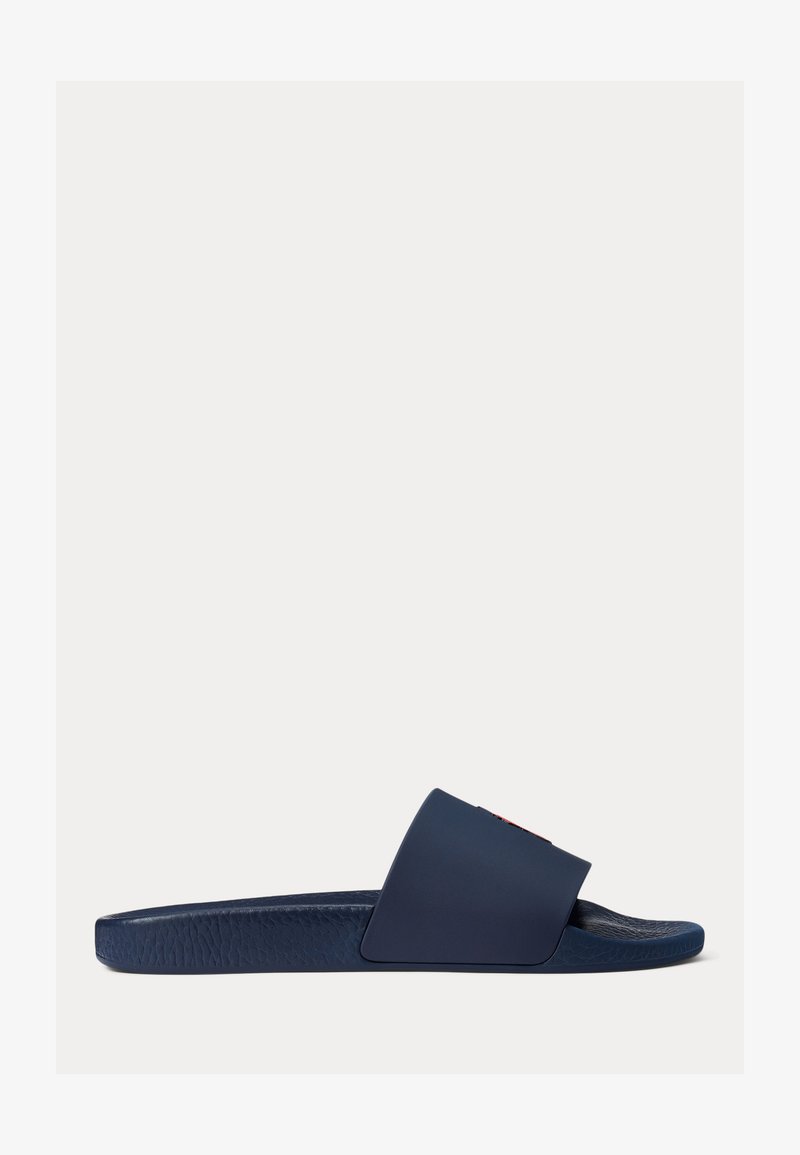 Navy blue slide sandal with textured sole and wide strap, shown in side view on white background.
