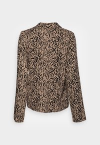 Blusa beige a maniche lunghe con un motivo a strisce di tigre nere. Realizzata in tessuto leggero e con una texture liscia. Orlo leggermente curvo.